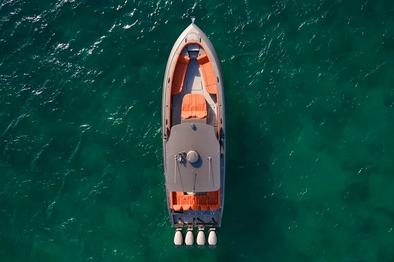 Slide: The Image of Top view of Midnight Express 37' Open boat on clear turquoise water. - 6