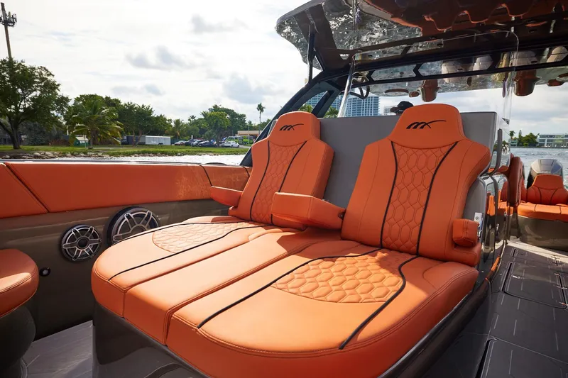 Slide: The Image of Luxurious orange seating on a Midnight Express 37' Open boat, featuring stylish design and waterfront view. - 8