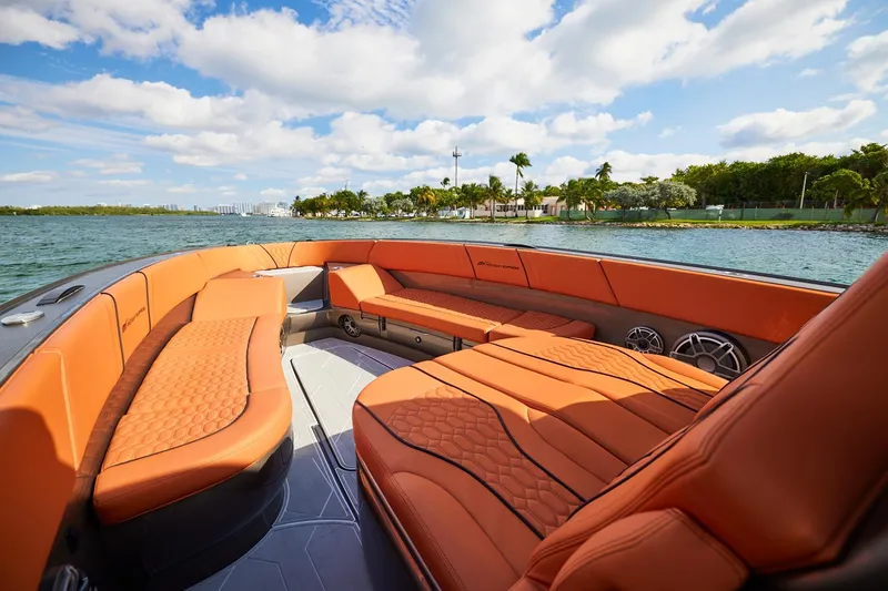 Slide: The Image of Luxurious interior of Midnight Express 37' Open boat with orange seating, on a sunny day. - 9