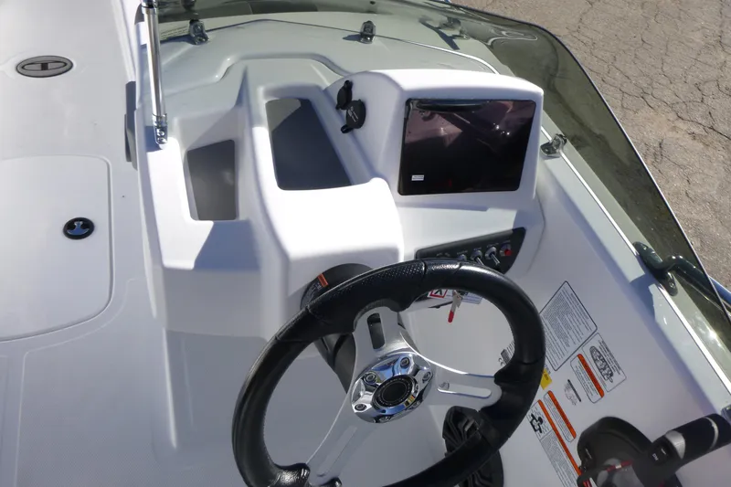 Slide: The Image of 2026 Tahoe T18 boat dashboard with steering wheel and control panel. - 11