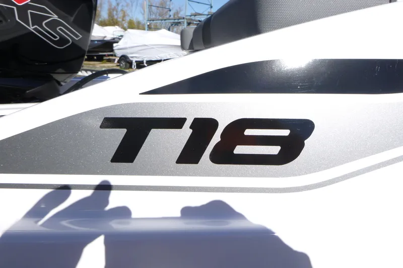 Slide: The Image of 2026 Tahoe T18 boat logo in black and silver on white surface. - 16