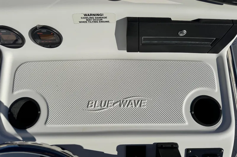 Slide: The Image of Dashboard of 2001 Blue Wave 220 Classic boat with gauges and storage compartment. - 11