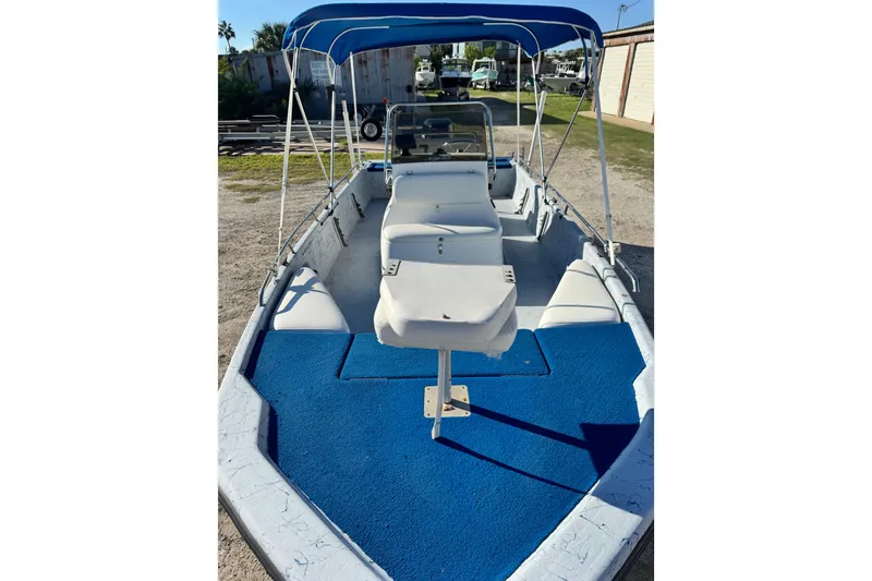 Slide: The Image of 2001 Blue Wave 220 Classic boat with blue carpet and canopy, docked outdoors. - 17