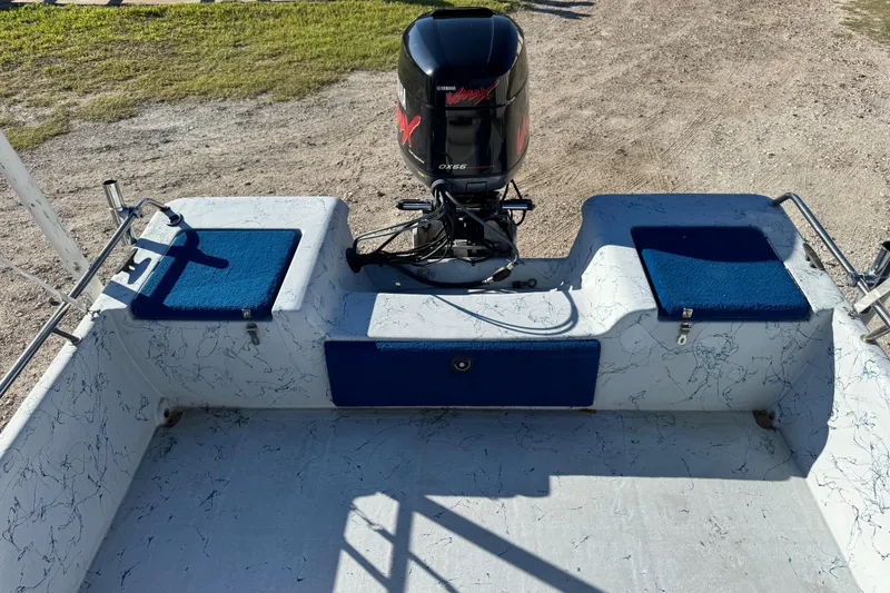 Slide: The Image of 2001 Blue Wave 220 Classic boat with Yamaha outboard motor, featuring blue cushioned seats. - 19