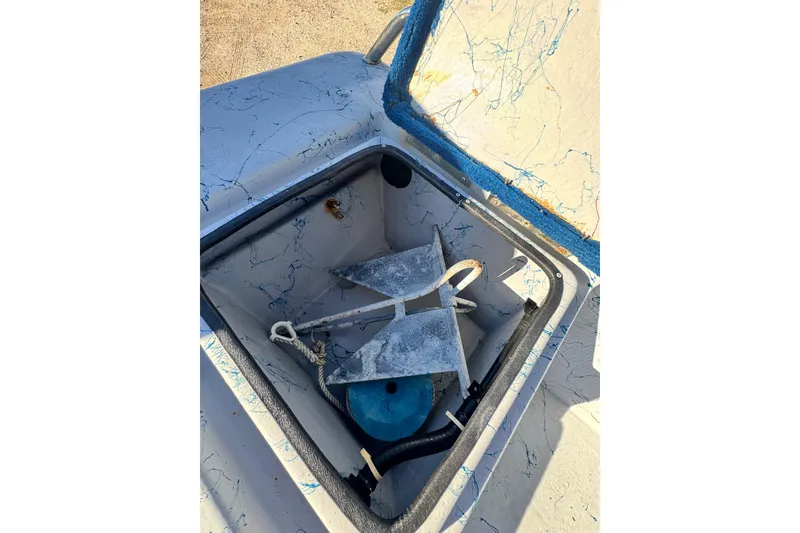 Slide: The Image of Open storage compartment on 2001 Blue Wave 220 Classic boat with anchor and rope. - 21