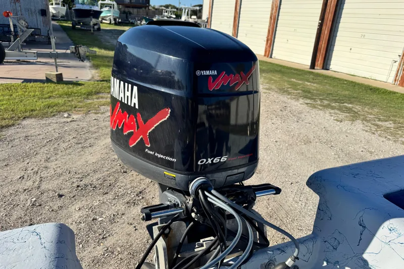 Slide: The Image of Yamaha VMAX outboard motor on 2001 Blue Wave 220 Classic boat, parked outdoors. - 22
