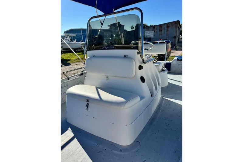 Slide: The Image of 2001 Blue Wave 220 Classic boat interior with seating and steering console. - 4