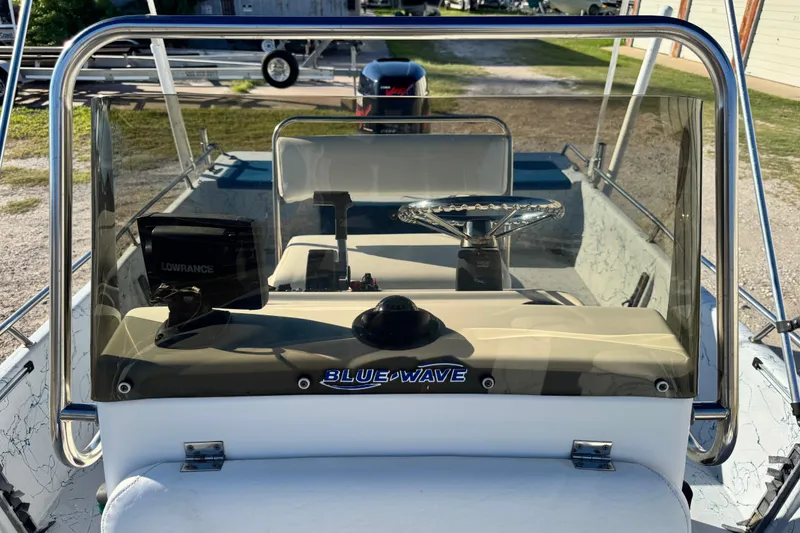 Slide: The Image of 2001 Blue Wave 220 Classic boat dashboard with steering wheel and Lowrance device. - 6