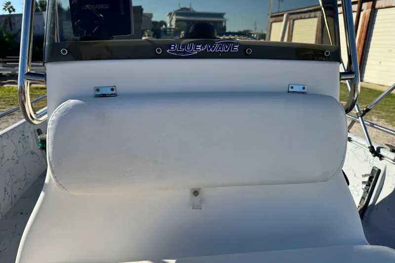 Slide: The Image of 2001 Blue Wave 220 Classic boat console with padded seat and steering wheel. - 7
