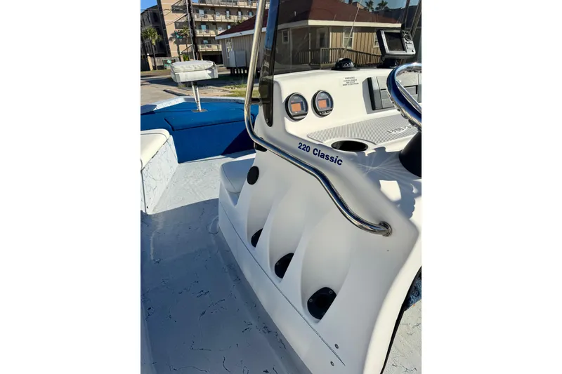 Slide: The Image of 2001 Blue Wave 220 Classic boat interior with steering console and seating. - 8