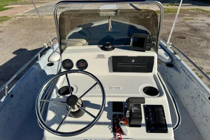 Slide: The Image of 2001 Blue Wave 220 Classic boat dashboard with steering wheel and navigation equipment. - 9