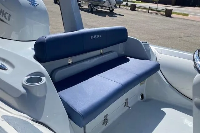 Slide: The Image of 2026 Brig Eagle 6 boat with blue seating and storage compartments. - 3