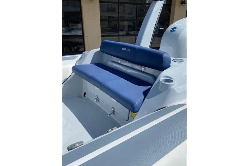 Slide: The Image of 2026 Brig Eagle 6 boat with blue seating and storage compartments. - 5