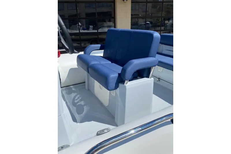 Slide: The Image of 2026 Brig Eagle 6 boat with blue cushioned seating and sleek design. - 6