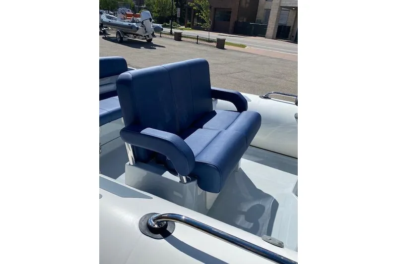 Slide: The Image of Blue seating on 2026 Brig Eagle 6 boat, parked outdoors. - 7