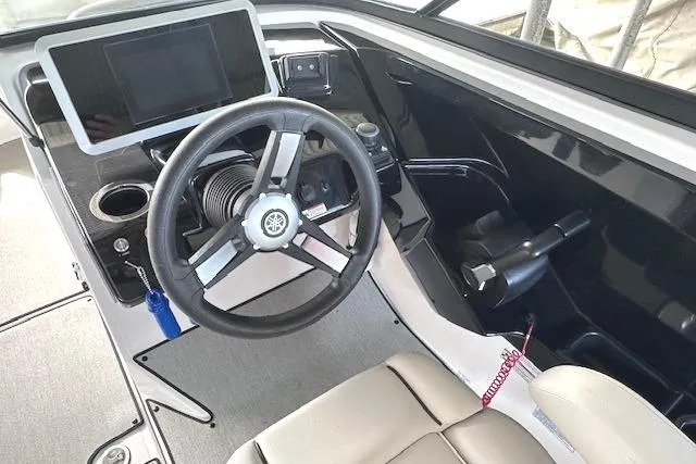 Slide: The Image of 2022 Yamaha Boats AR250 helm with steering wheel and touchscreen display. - 12