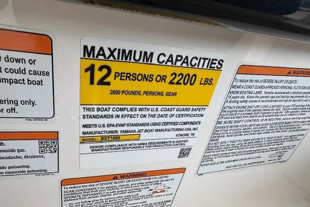 Slide: The Image of 2022 Yamaha Boats AR250 capacity label: 12 persons or 2200 lbs, 2600 pounds total. - 13