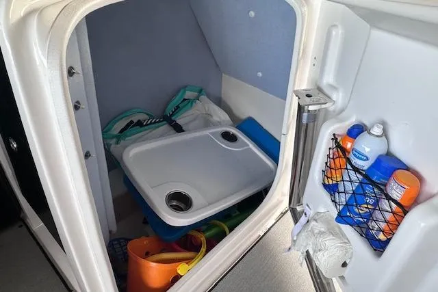 Slide: The Image of 2022 Yamaha AR250 boat storage compartment with accessories and supplies. - 14