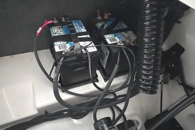 Slide: The Image of Batteries and wiring inside a 2022 Yamaha Boats AR250 engine compartment. - 19