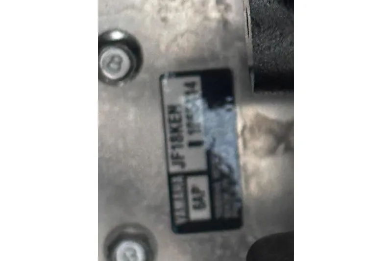 Slide: The Image of Close-up of a 2022 Yamaha Boats AR250 engine plate with visible screws. - 22