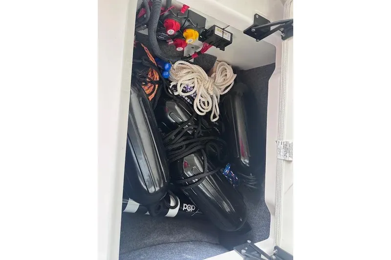 Slide: The Image of Storage compartment of 2022 Yamaha AR250 boat with ropes and equipment. - 23