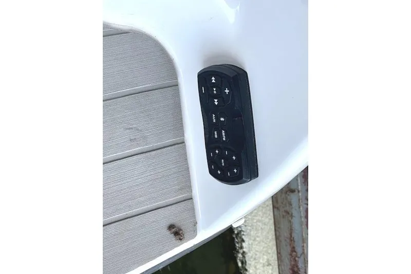 Slide: The Image of Control panel on a 2022 Yamaha Boats AR250, featuring audio and navigation buttons. - 26