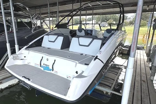 Slide: The Image of 2022 Yamaha AR250 boat docked, showcasing sleek design and spacious seating. - 3