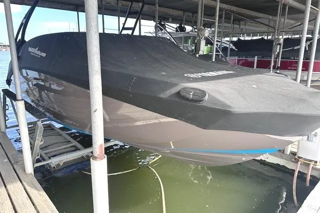 Slide: The Image of 2022 Yamaha Boats AR250 covered and docked in a marina. - 30