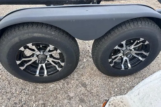 Slide: The Image of 2022 Yamaha Boats AR250 trailer wheels on gravel surface. - 41