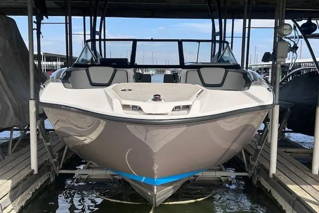 Slide: The Image of 2022 Yamaha Boats AR250 docked, front view, in a marina setting. - 5