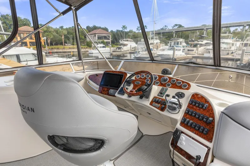 Slide: The Image of Helm of 2008 Meridian 408 Motoryacht with luxurious controls and marina view. - 16
