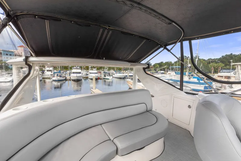 Slide: The Image of 2008 Meridian 408 Motoryacht interior with marina view, featuring comfortable seating and canopy. - 18