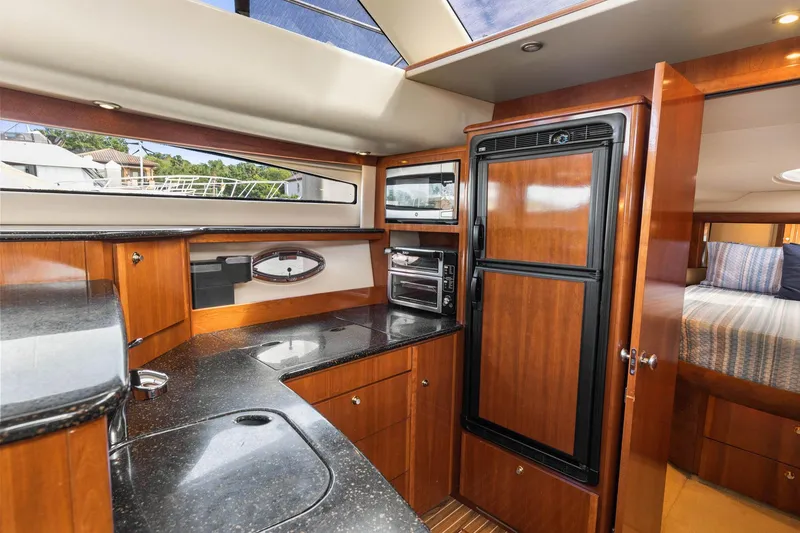 Slide: The Image of Luxurious 2008 Meridian 408 Motoryacht interior with modern kitchen and cozy bedroom. - 32