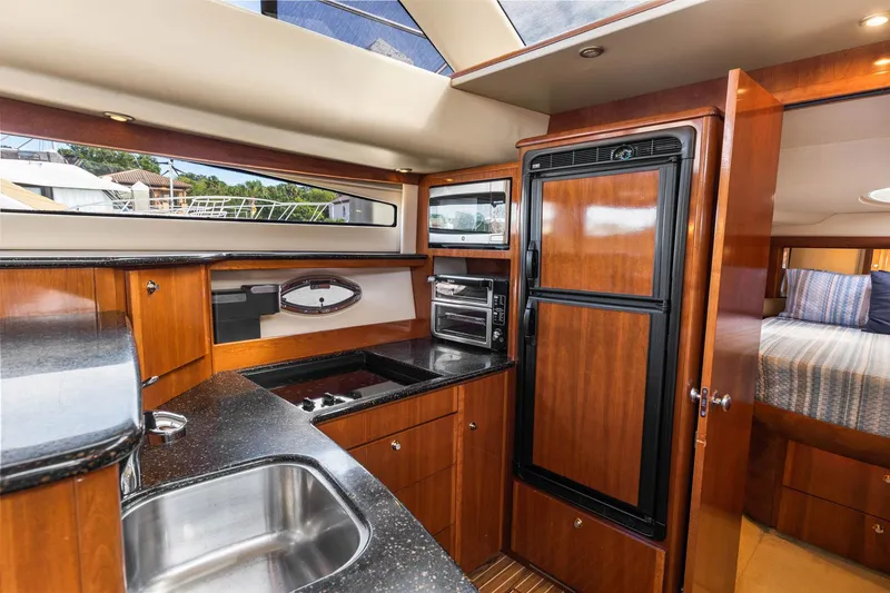 Slide: The Image of Luxurious 2008 Meridian 408 Motoryacht kitchen with wood cabinetry and modern appliances. - 33