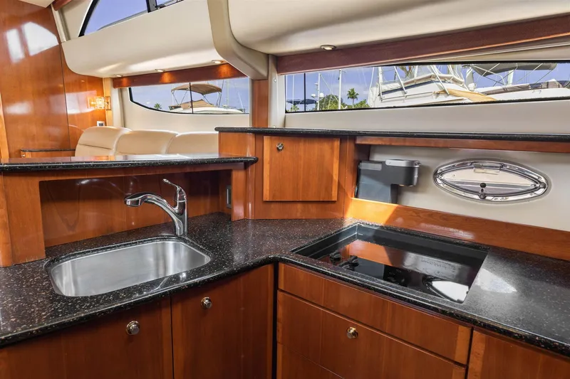 Slide: The Image of Luxurious kitchen interior of 2008 Meridian 408 Motoryacht with sleek wood cabinetry. - 34