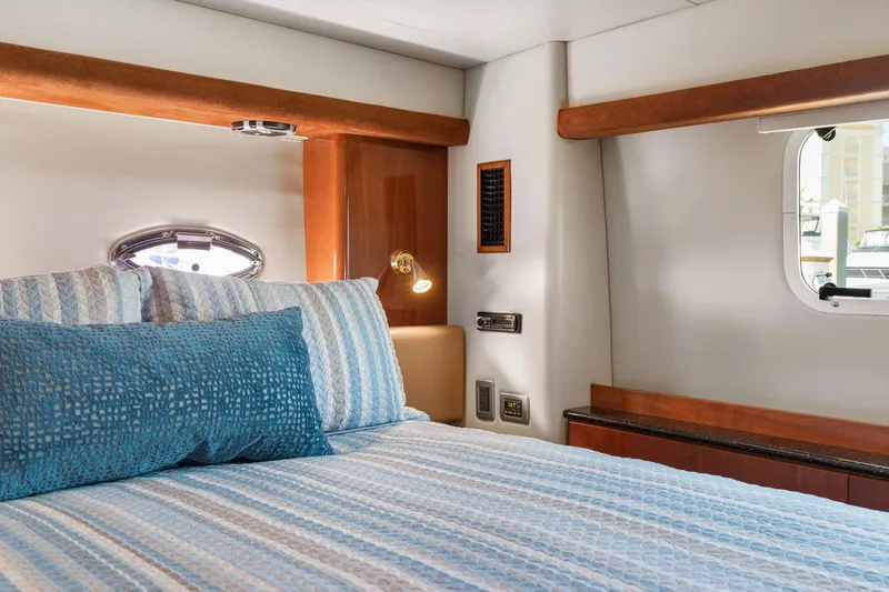 Slide: The Image of Luxurious bedroom interior of 2008 Meridian 408 Motoryacht with elegant bedding and porthole view. - 43