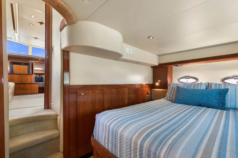 Slide: The Image of Luxurious bedroom interior of 2008 Meridian 408 Motoryacht with striped bedding and wood accents. - 45