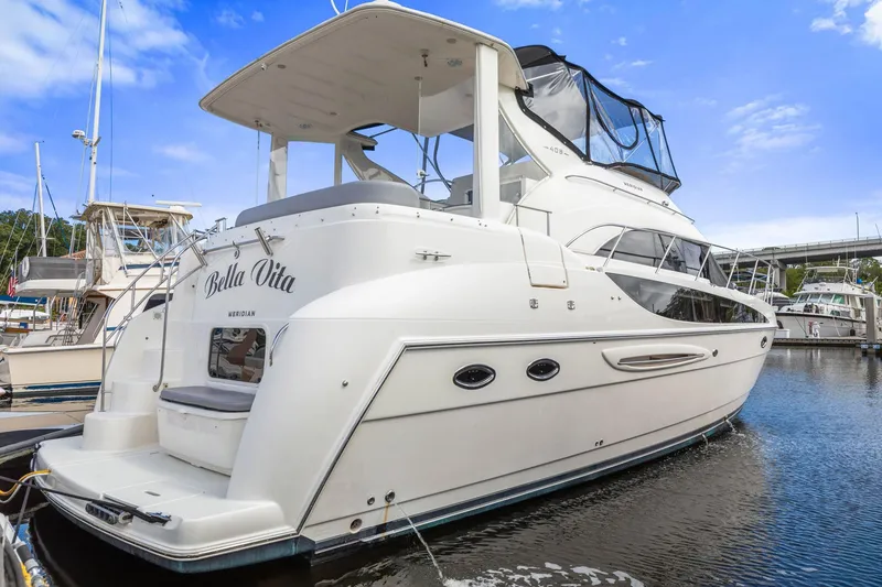 Slide: The Image of 2008 Meridian 408 Motoryacht docked, featuring sleek design and spacious upper deck. - 53