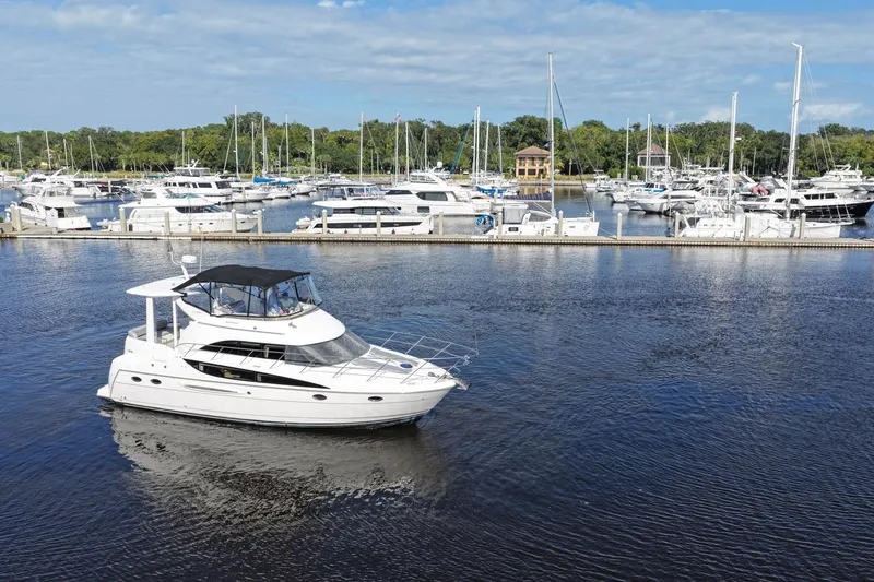 Slide: The Image of 2008 Meridian 408 Motoryacht cruising in a marina with other boats docked nearby. - 55