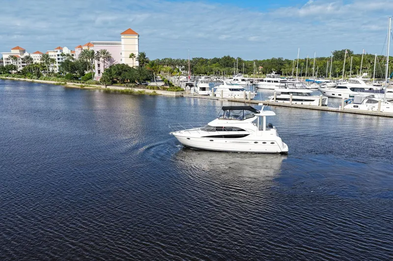 Slide: The Image of 2008 Meridian 408 Motoryacht cruising near marina with waterfront buildings in background. - 56