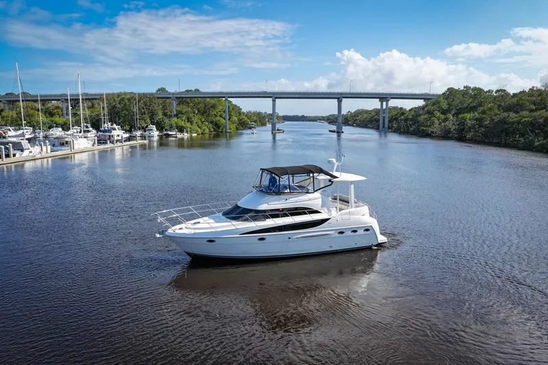 Slide: The Image of 2008 Meridian 408 Motoryacht cruising on a scenic river under a clear blue sky. - 62