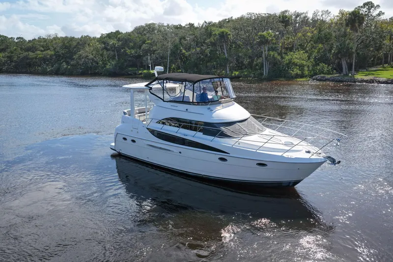 Slide: The Image of 2008 Meridian 408 Motoryacht cruising on a serene river with lush greenery. - 63