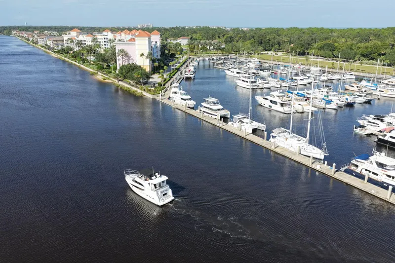 Slide: The Image of Aerial view of 2008 Meridian 408 Motoryacht cruising near marina with docked boats. - 65