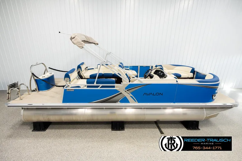 The Image of 2026 Avalon LSZ QLS pontoon boat in showroom, featuring blue and silver design. - 1