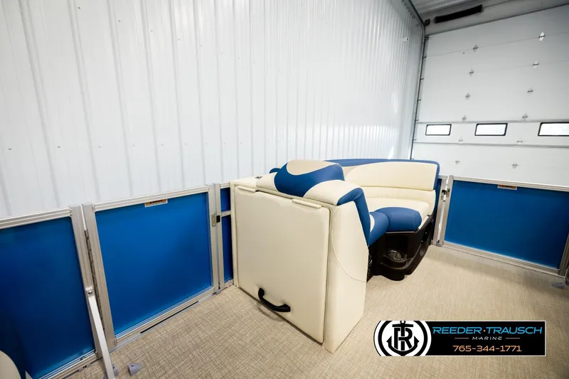 Slide: The Image of 2026 Avalon LSZ QLS pontoon interior with blue and white seating in a garage. - 28
