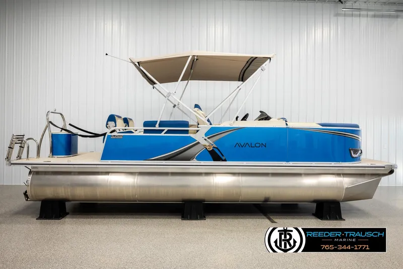 Slide: The Image of 2026 Avalon LSZ QLS pontoon boat with blue exterior and canopy in showroom. - 5