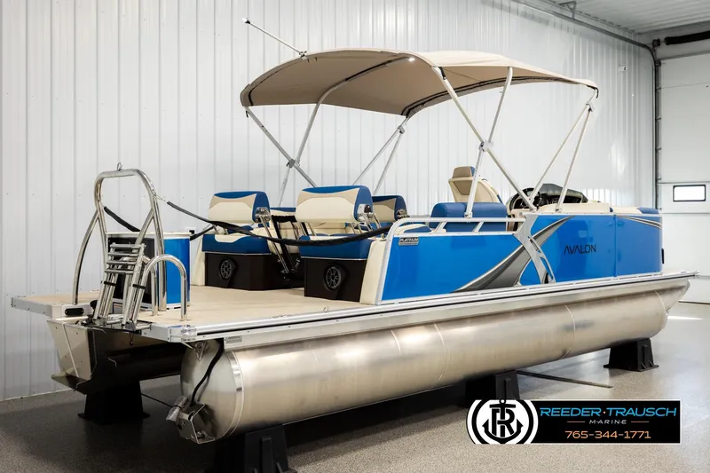Slide: The Image of 2026 Avalon LSZ QLS pontoon boat with blue exterior in a showroom. - 6