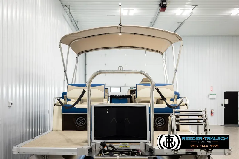 Slide: The Image of 2026 Avalon LSZ QLS pontoon boat in showroom, featuring canopy and seating. - 7