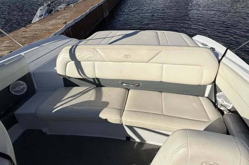 Slide: The Image of 2008 Cobalt 202 boat interior with beige seating near a dock. - 12
