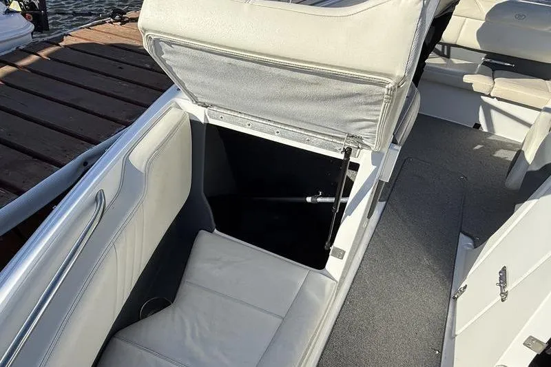 Slide: The Image of 2008 Cobalt 202 boat interior with open storage compartment and cushioned seating. - 15